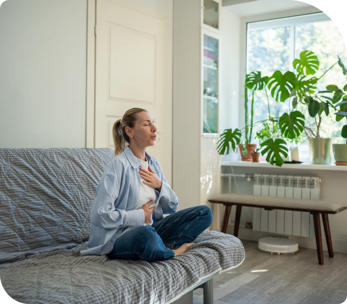 Woman meditating on living room couch