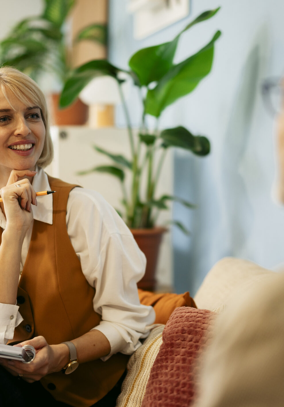 Smiling woman holding pen and notebook