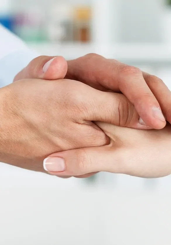 Compassionate healthcare professional holding hand